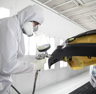 Collision Center Technician Painting a Vehicle | Toyota of Waco in Waco TX
